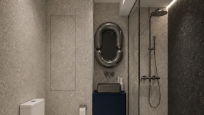 A modern bathroom with a toilet, sink, and shower. - Ross Street Hotel (San Ġiljan)