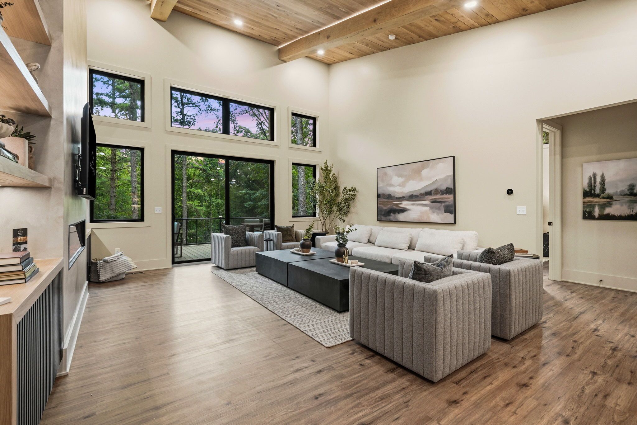 A spacious living room with a large sofa set, a coffee table, and a fireplace.
