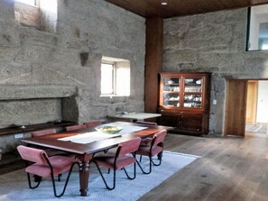 A dining area with a wooden table, chairs, and a cabinet with glass doors. - Picturesque Villa with Private Pool by Interhome (Alvite)