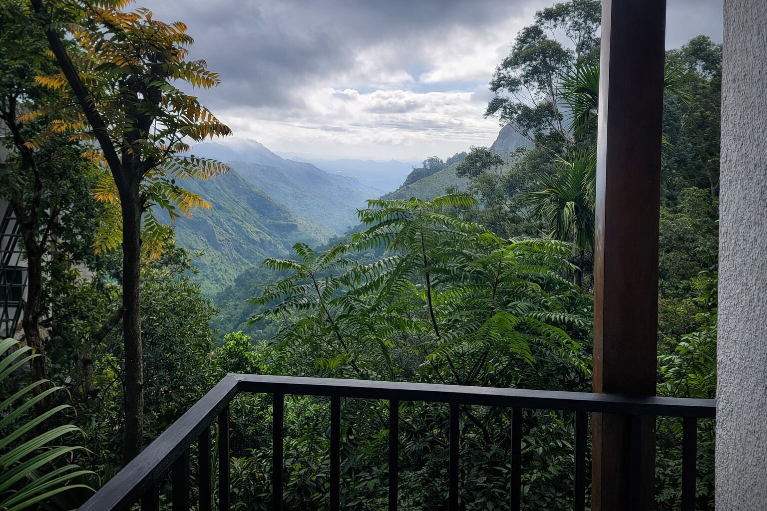 A balcony with a view of a mountainous landscape.