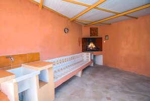 Una habitación con chimenea, un banco y un lavamanos.