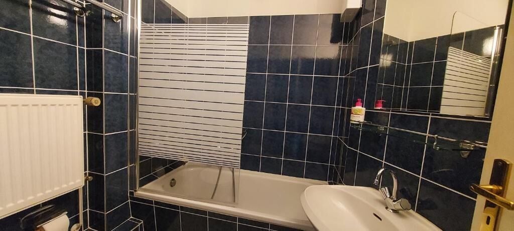 A bathroom with a bathtub, a sink, and a toilet.