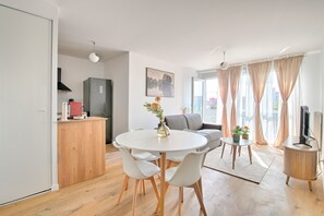 Un espacio habitable moderno con comedor, cocina y zona de estar.