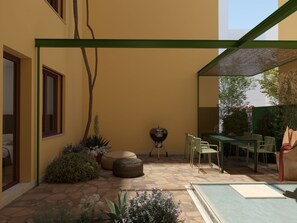 A covered patio area with a barbecue grill, outdoor seating, and a variety of plants. - Suite 11 Athens (Athina)