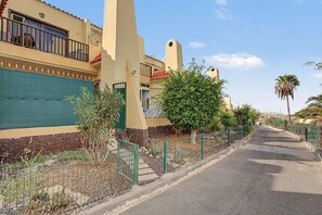 A residential street with houses, a clear sky, and a palm tree. - Vacation Apartment 'Vacanze Mareverde' with Mountain View, Shared Pool and Wi-Fi (Costa Adeje)