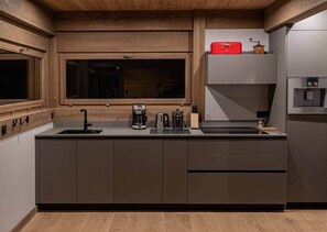 A modern kitchen with a built-in window, a coffee maker, a kettle, and a red storage box on the countertop. - Chalet Fleur des Vosges, panoramic view of La Bresse (La Bresse)