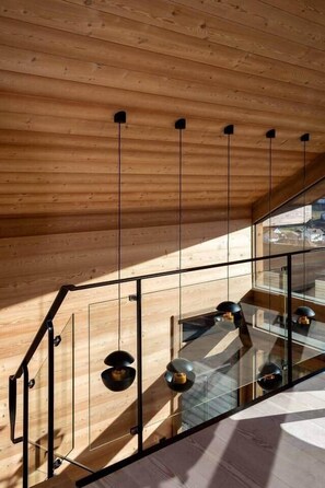 A modern interior with a wooden ceiling, glass railing, and pendant lights. - Chalet Fleur des Vosges, panoramic view of La Bresse (La Bresse)
