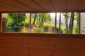 A wooden interior with a view of a forested outdoor area through a window. - Chalet Fleur des Vosges, panoramic view of La Bresse (La Bresse)