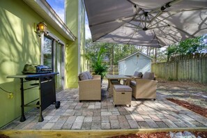 A patio with outdoor furniture, a barbecue grill, and a covered area. - Bright Horizons Hideaway w/POOL- 18 min to MAYO (Jacksonville)