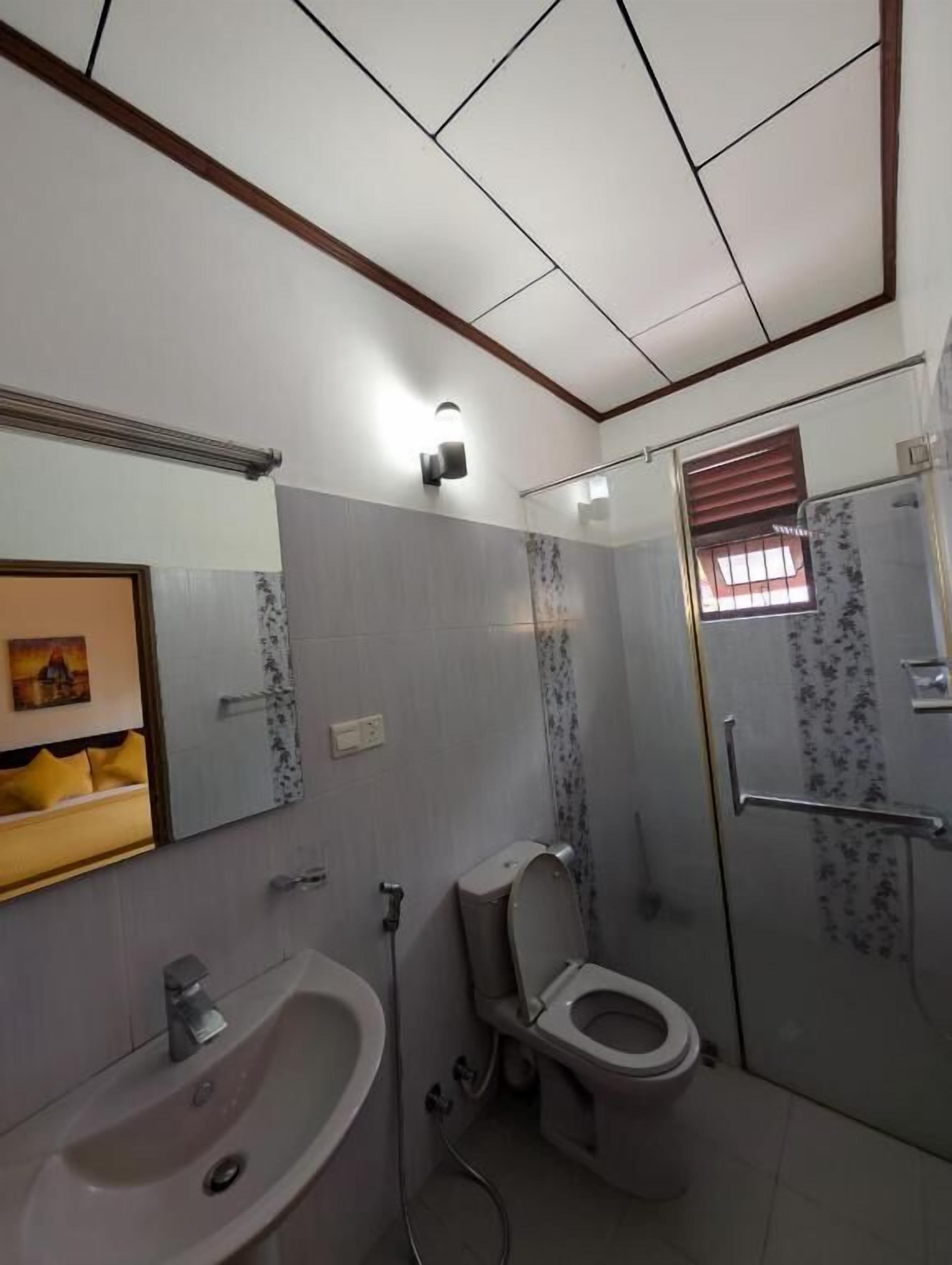 A bathroom with a sink, toilet, and shower.