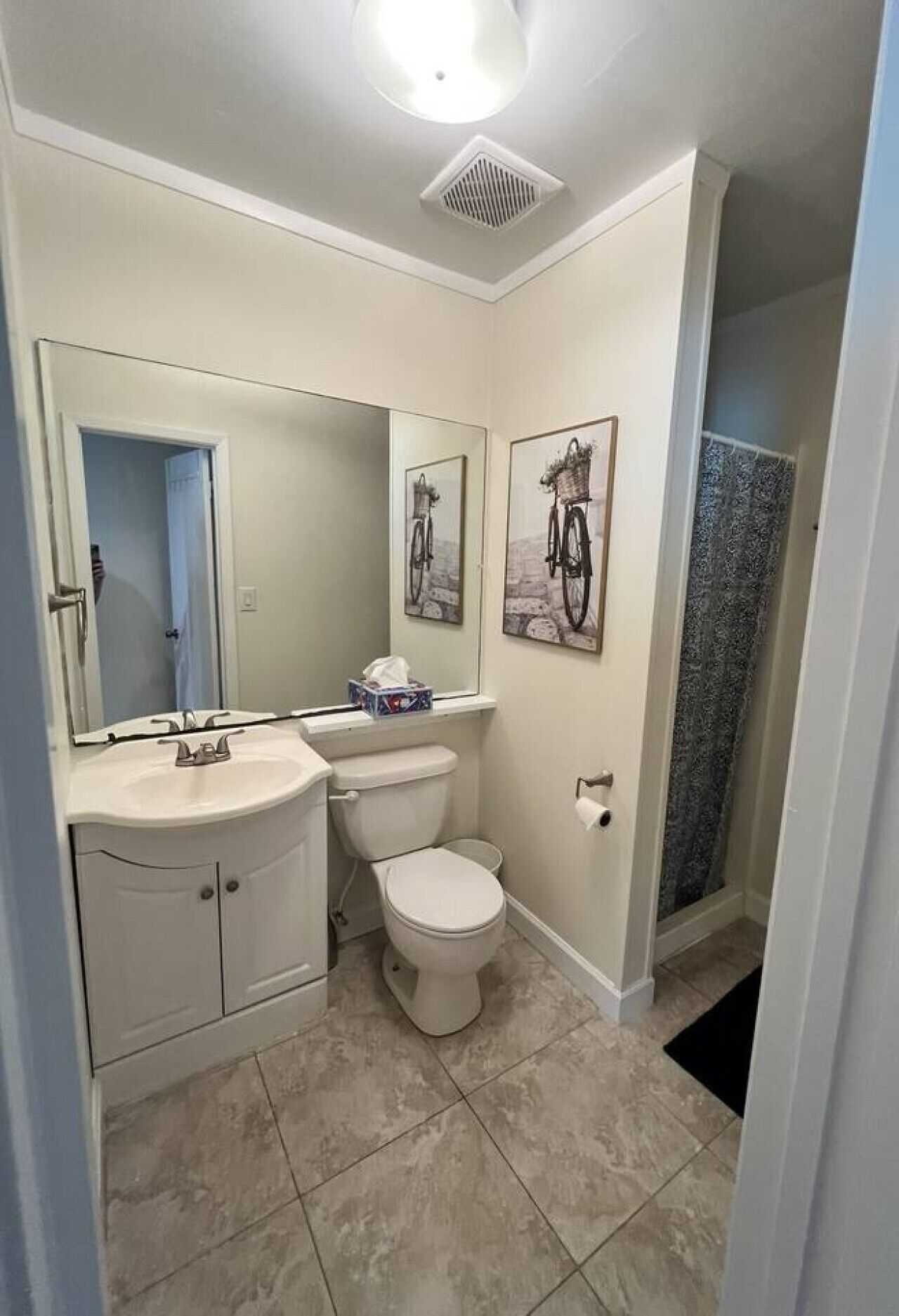 A bathroom with a toilet, sink, and shower.