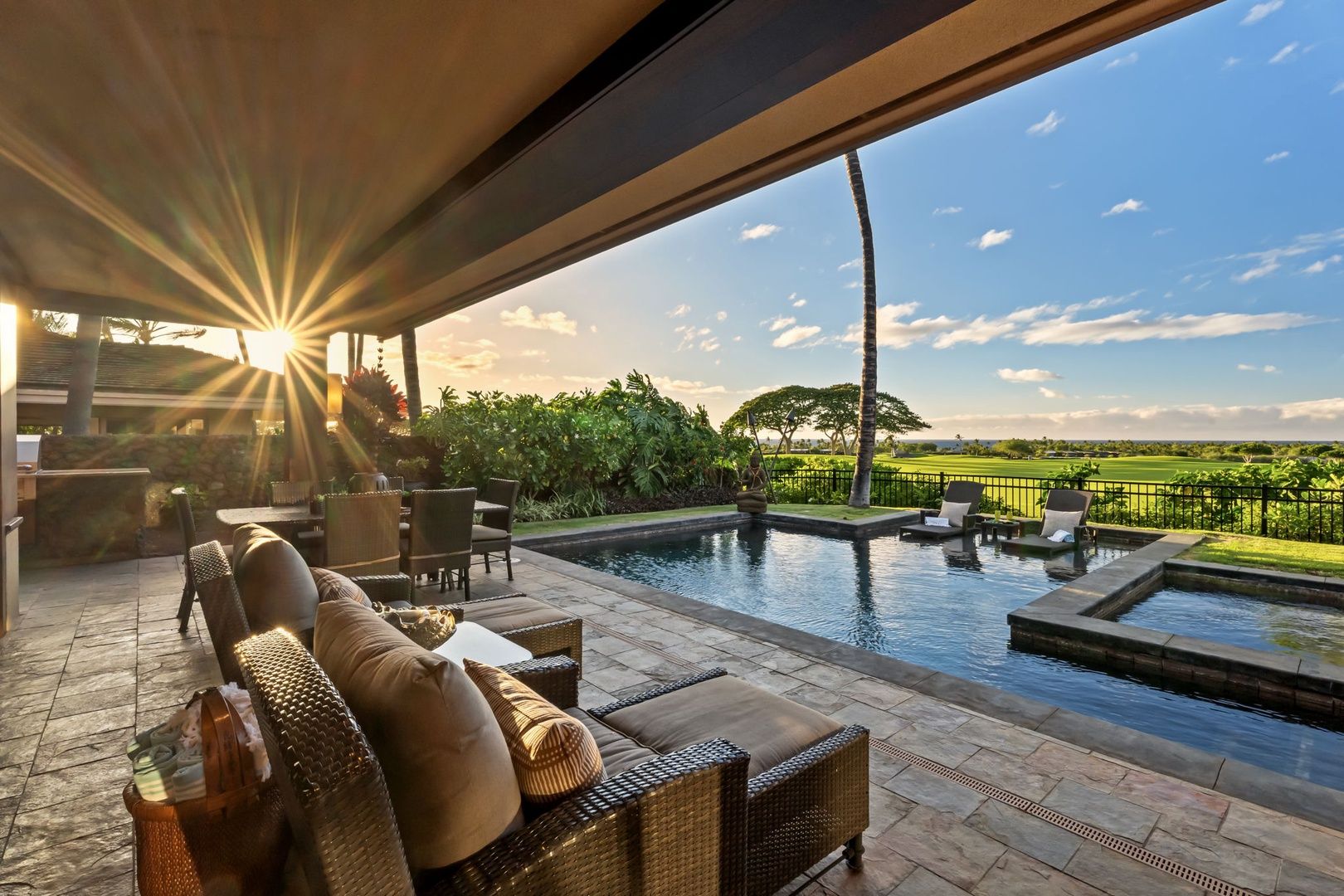 End the day on the lanai as the sun drops low and the pool catches the last ligh
