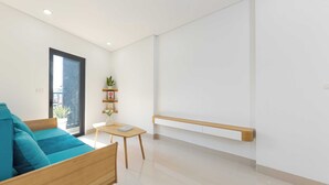 Una sala de estar moderna con un sofá, una mesita y una planta.