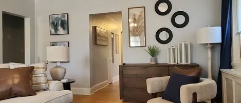 A modern living room with a ceiling fan, a round coffee table, and a sofa.