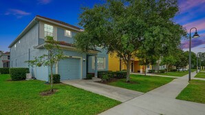 A residential street with houses, sidewalks, and trees. - Wish Upon A Star in Kissimmee (Kissimmee)