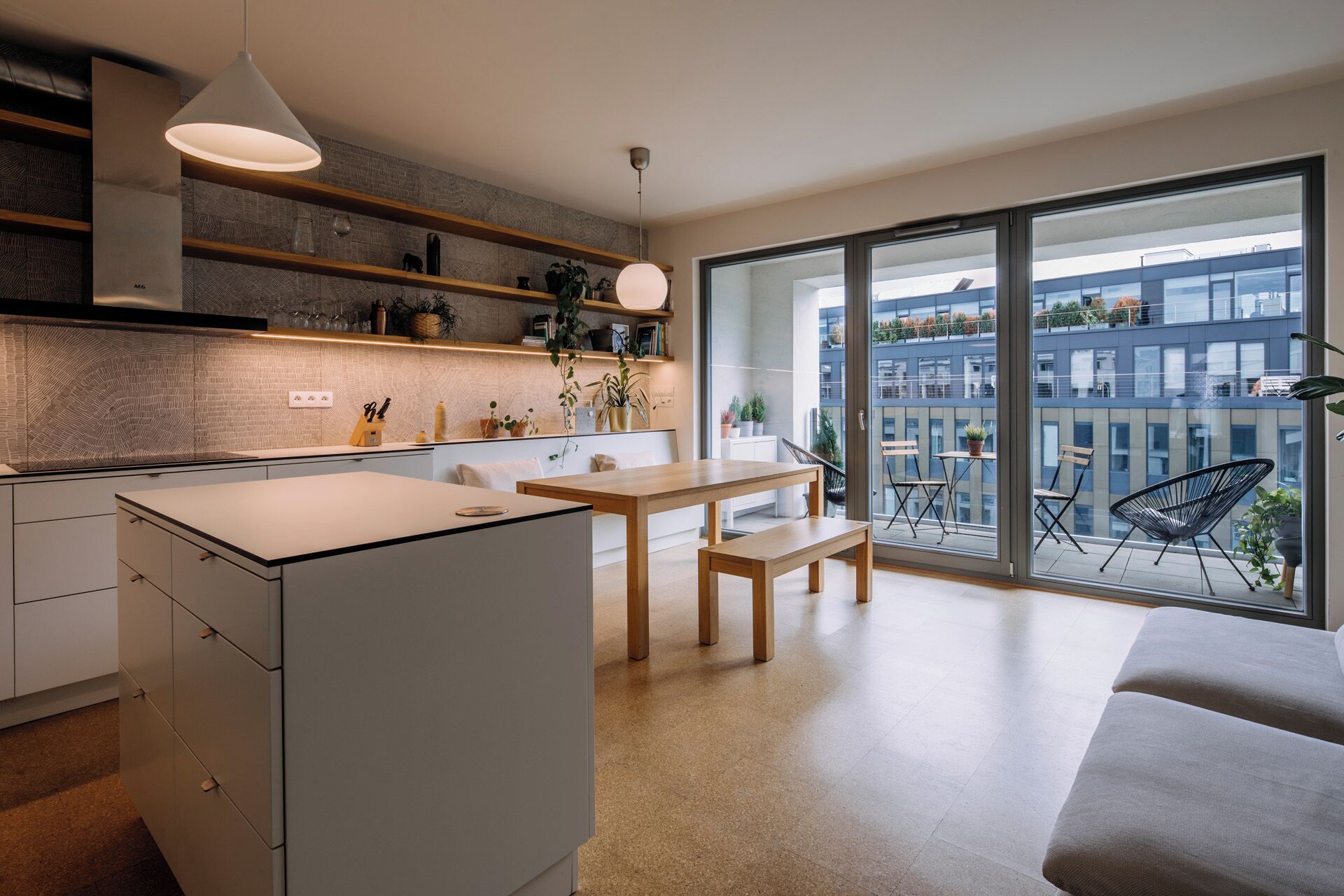 Une cuisine moderne avec un coin repas, de grandes fenêtres et une vue sur la ville.