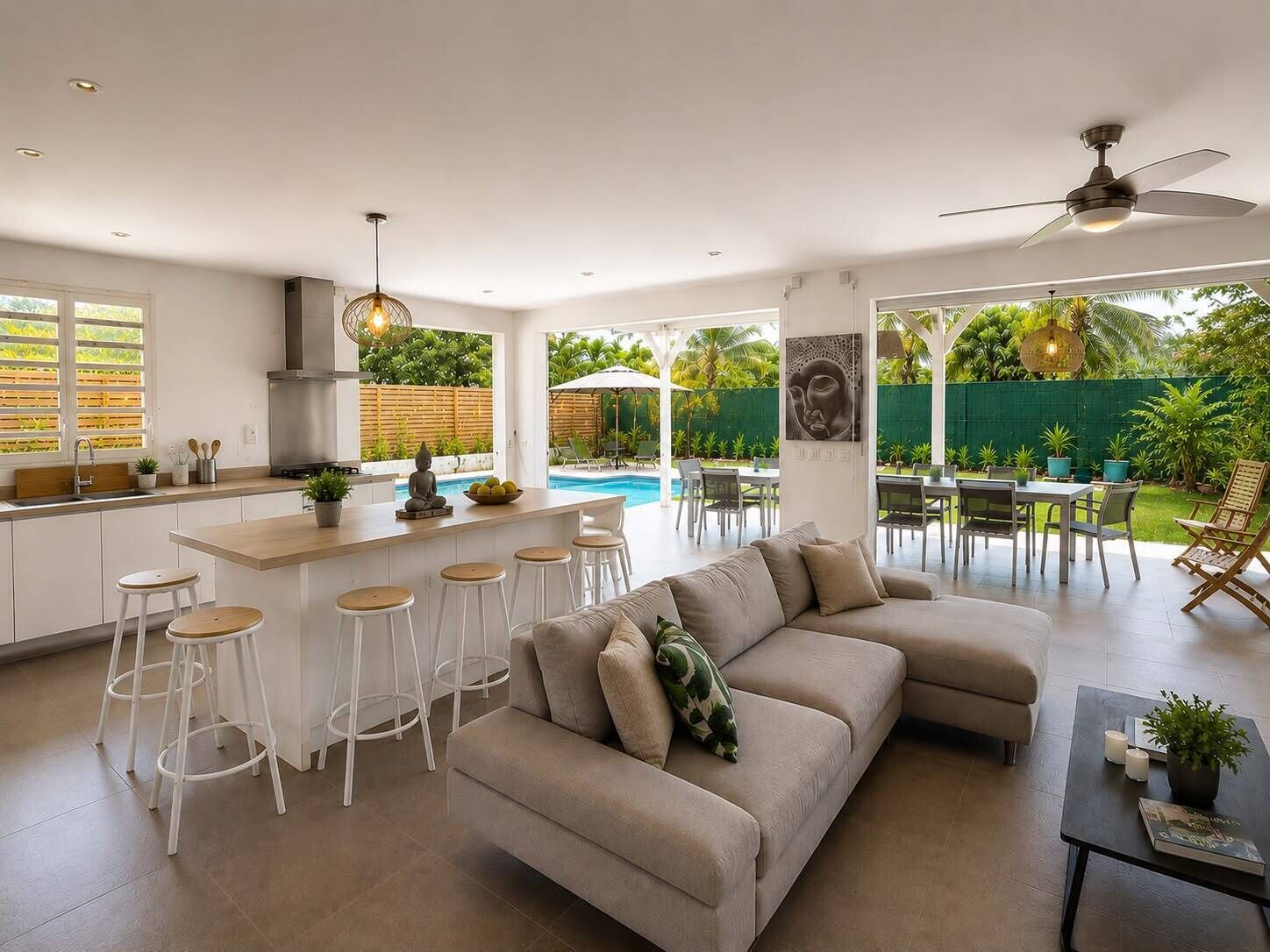 A modern kitchen with a bar area, a dining space with outdoor seating, and a pool.