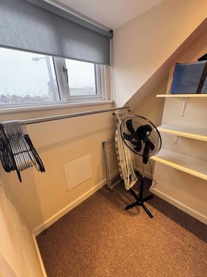 A room with a radiator, a standing fan, a window with blinds, and a radiator cover. - #81 Stylish TopFloor|for 2|10 mins to Brueton Park (Shirley)