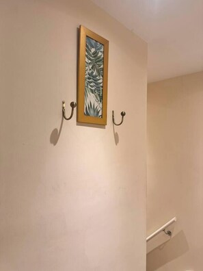 A framed artwork on a wall with two wall-mounted hooks. - #81 Stylish TopFloor|for 2|10 mins to Brueton Park (Shirley)
