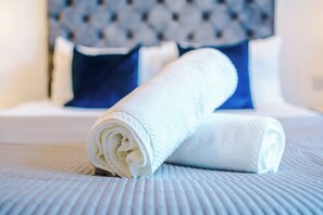 A neatly folded white towel on a textured bedspread. - #82 Stylish Shirley Home Sleeps 8 NEC Solihull BHX (Shirley)