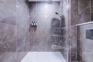 A modern bathroom with a glass shower enclosure, marble tiles, and a white floor. - #82 Stylish Shirley Home Sleeps 8 NEC Solihull BHX (Shirley)