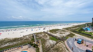 A beach with a pool area, a boardwalk, and a view of the ocean. - Seaside Beach & Racquet 3801 (Orange Beach)