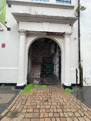 A white building with a brick pathway leading to an arched entrance. - #84 Large JQ apartment sleeps 9 (West Midlands)
