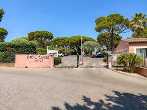 A gated entrance to a private property named Parc Oasis.