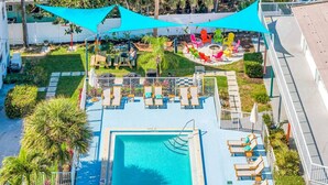 A rooftop pool with lounge chairs, a fire pit, and a garden area with colorful chairs. - Kemp`s Ridley 8- Oceanfront King Studio- HTD Pool (Lauderdale-by-the-Sea)