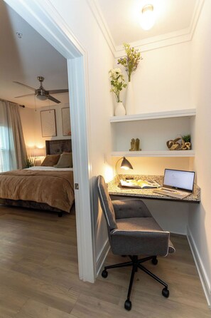 A bedroom with a bed, a desk with a laptop, a chair, and a ceiling fan. - Lux Master bedroom in a 3 bed 2 bath house (Charlotte)