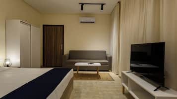 A hotel room with a bed, a sofa, a television, and a wardrobe.