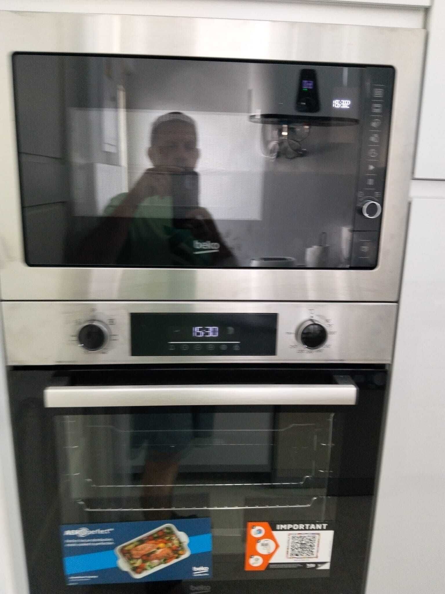 A kitchen with a built-in oven and microwave.
