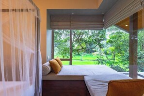 A bedroom with a large window, a bed, and a canopy. - ONA Garden Villa: Deluxe Double/Twin Room (Galle)