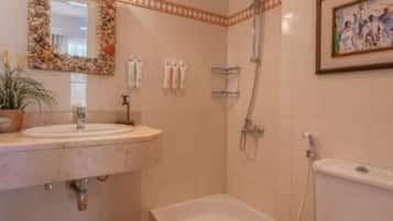 A bathroom with a bathtub, toilet, and sink.
