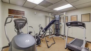 A fitness room with exercise equipment including a treadmill, elliptical, and weight machine. - Ski, Soak & Relax | Cozy Beech Mountain Condo (Beech Mountain)