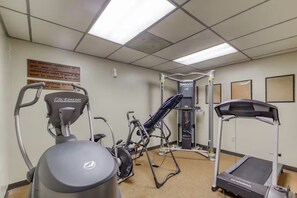A fitness room with exercise equipment including a treadmill, elliptical, and weight machine. - Ski, Soak & Relax | Cozy Beech Mountain Condo (Beech Mountain)