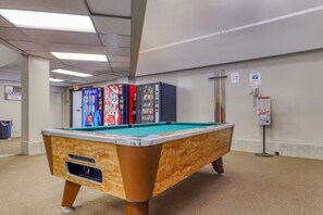 A pool table in a room with vending machines and a trash bin. - Ski, Soak & Relax | Cozy Beech Mountain Condo (Beech Mountain)