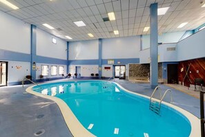 An indoor swimming pool with clear water, surrounded by blue walls and a tiled ceiling. - Ski, Soak & Relax | Cozy Beech Mountain Condo (Beech Mountain)