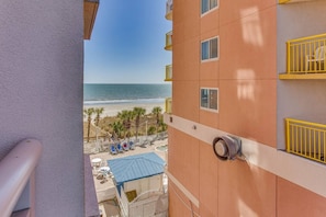A balcony with a view of a beach and ocean. - Ocean View Studio | Bay Watch Resort + Pools (North Myrtle Beach)