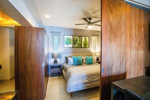 A bedroom with a bed, bedside tables, a ceiling fan, and framed artwork on the wall. - Amazing V177 Ocean Chic (Puerto Vallarta)