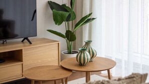 A modern living room with a TV, wooden furniture, and potted plants. - Polacos Residence | 2BR | Apt H by LovelyStay (Vila Nova de Gaia)