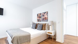 A modern bedroom with a bed, bedside tables, and abstract wall art. - Polacos Residence | 1BR | Apt D by LovelyStay (Vila Nova de Gaia)