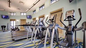 A gym with treadmills, elliptical machines, and stationary bikes. - Birdie Bungalow - Four Bedroom House, Sleeps 8 (Kissimmee)