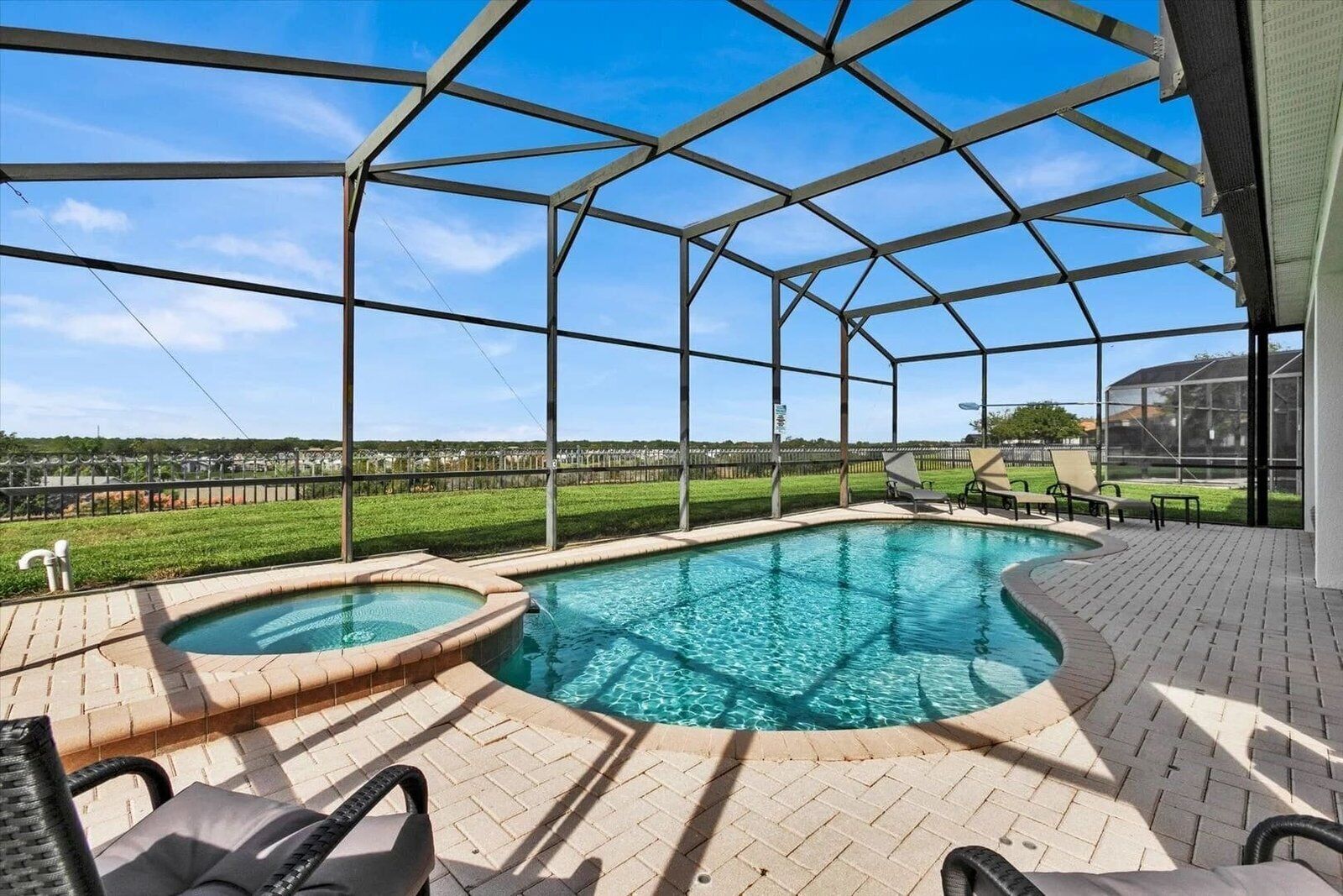 A covered outdoor swimming pool with a view of a residential area.