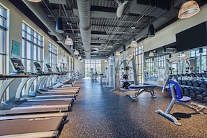A gym with treadmills, weight machines, and dumbbells. - New Listing! 7 miles Disney/South facing pool and spa / (Kissimmee)