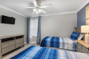 A bedroom with two beds, a ceiling fan, a TV, and a dresser. - Morning Mist - Six Bedroom House, Sleeps 12 (Kissimmee)