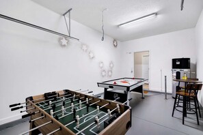 A room with a foosball table, a pool table, and a bar area. - Pooch Parlour - Six Bedroom House, Sleeps 14 (Kissimmee)