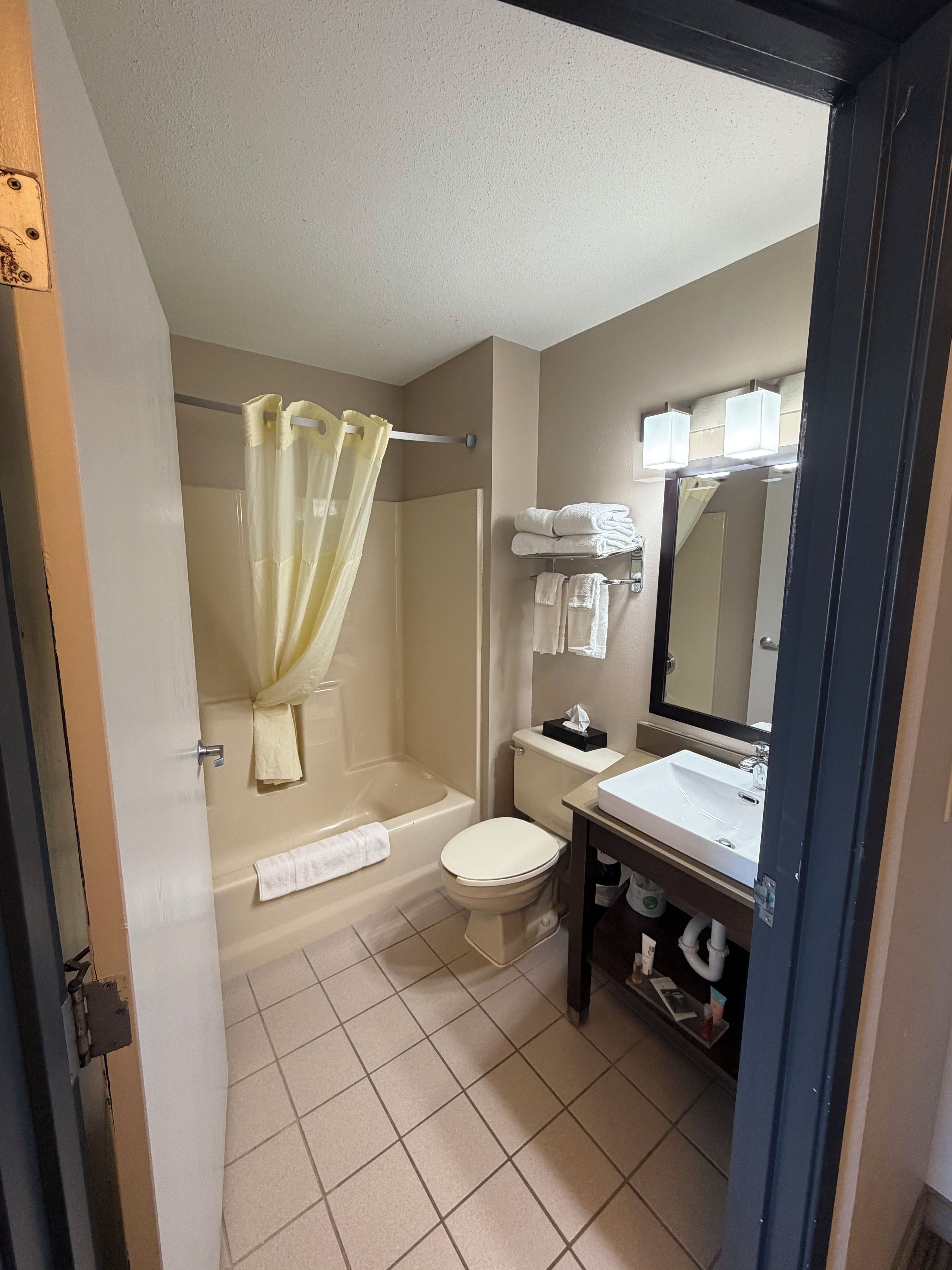 A bathroom with a bathtub, toilet, and sink.