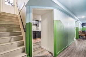 A staircase leading to a kitchen area with cabinets and a window. - Aloha Springs! Private Heated Pool & Hot Tub (Colorado Springs)
