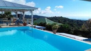 A swimming pool with a view of a mountainous landscape.